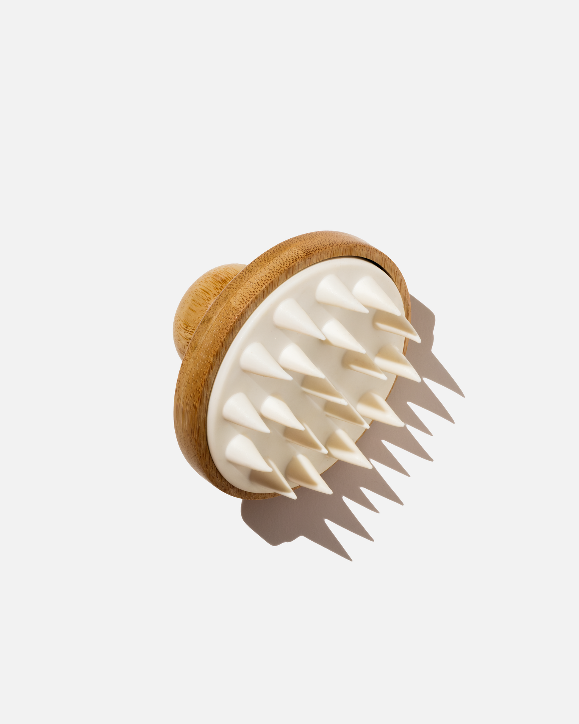 LoveKyir Stimulating Scalp Tool with a light wood base and white silicone bristles